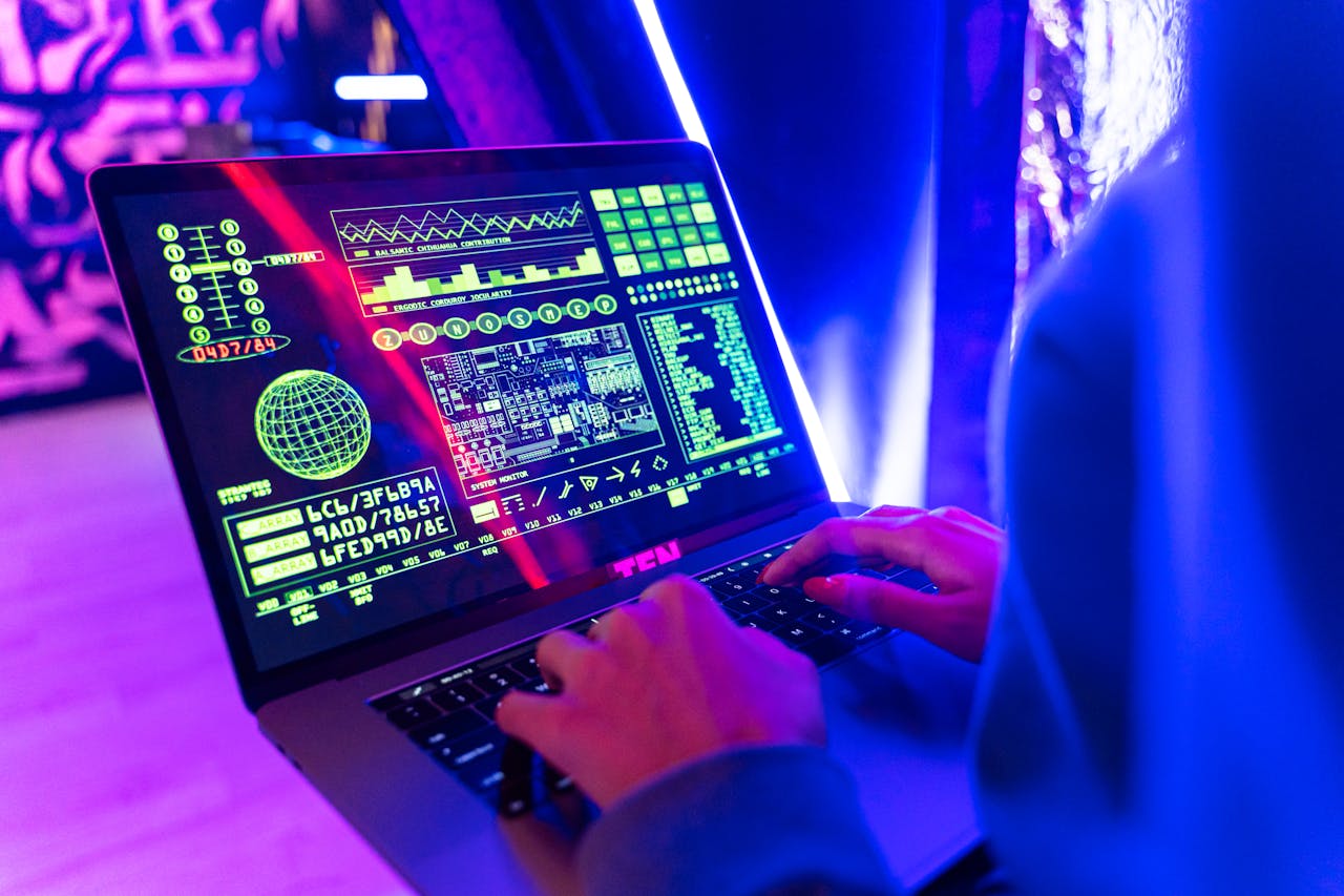 cta-02 Person typing on a laptop with vibrant digital data display, highlighting cyber security.
